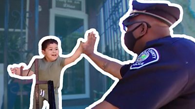 A police officer high fives a young child
