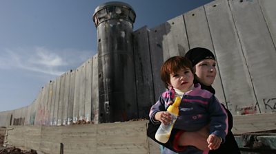 Mother and child by west bank barrier