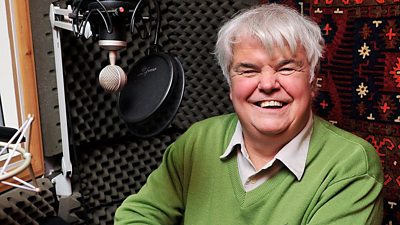 Peter White in a radio studio, smiling to camera