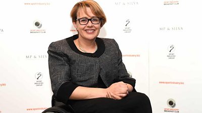 Baroness Tanni Grey-Thompson at a photo call, smiling to camera and clasping her hands together