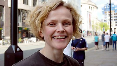 Tight head and shoulders of Maxine Peake smiling on a street