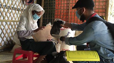 A medical volunteer tends to a refugee