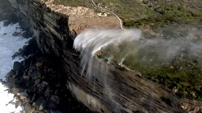 Waterfall flowing in reverse over cliff