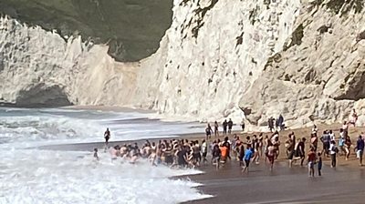 More than 20 people linked arms to enter the sea at Durdle Door and bring a swimmer back to shore.
