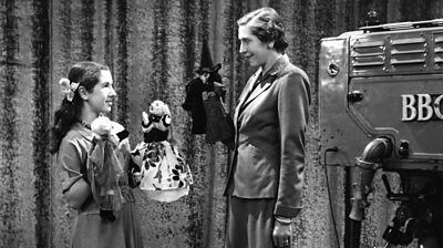 Picture shows Rosemary Broad from Northern Ireland showing Olive Shapley, the compere, some of her puppets which she makes from papiere mache in 1953