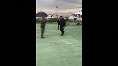 Lukashenko carries assault rifle as he gets off helicopter