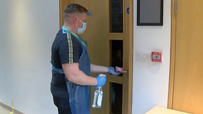 man cleaning door