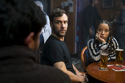 Cormoran Strike (TOM BURKE), Jimmy Knight (NICK BLOOD), Flick Purdue (SAFFRON COOMBER)(Image Credit: BBC/Bronte Films/Steffan Hill)