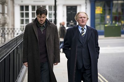 Cormoran Strike (TOM BURKE), Jasper Chiswell (ROBERT GLENISTER)(Image Credit: BBC/Bronte Films/Steffan Hill)