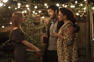 Robin Ellacott (HOLLIDAY GRAINGER), Cormoran Strike (TOM BURKE), Lorelei (NATALIE GUMEDE) in Lethal White (Image Credit: BBC/Bronte Films/Steffan Hill)