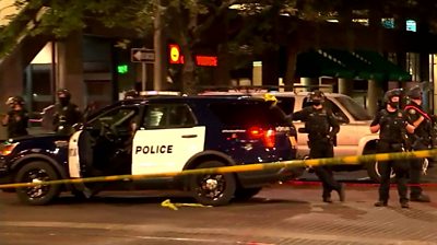 Police car and police officers at scene of shooting in Portland