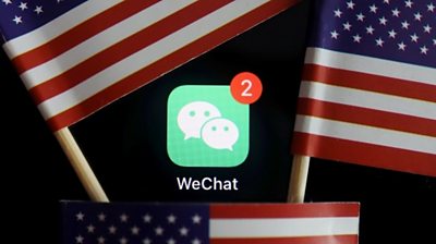 The messenger app WeChat is seen among U.S. flags in this illustration picture