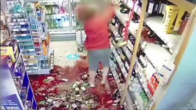 Wine being knocked from shelves