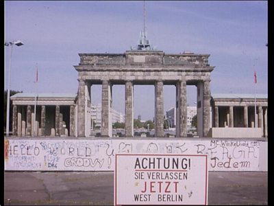 The Brandenburg Gate with the Berlin wall in front of it. The wall has graffiti all over it