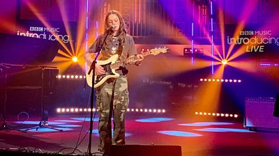 Holly Humberstone on stage with guitar performing at BBC Music Introducing