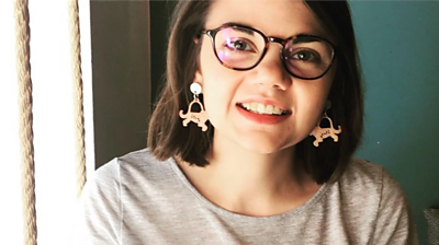 Sophie Ludkin mid shot, wearing animal earrings and smiling