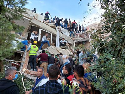 People moving rubble at a collapsed building
