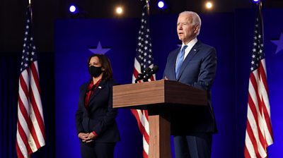 Joe Biden and Kamala Harris standing on stage