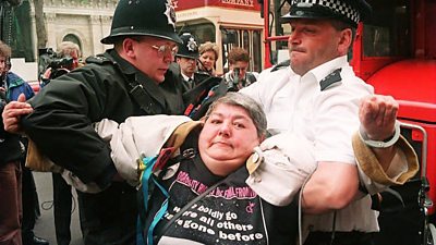 Protester held by police