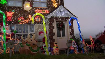 The front of the house covered in lights