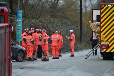 Firemen outside explosion scene