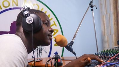 An announcer on air at Lion Mountain Radio