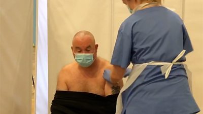 Craig Atkins having a Covid-19 vaccine administered