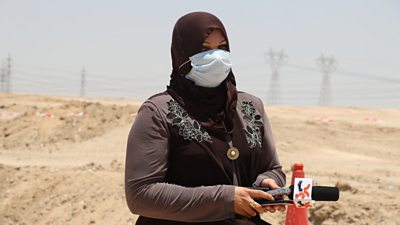 Al Mirbad editor Nihad al-Jaberi shown with a microphone in a dusty outdoor setting