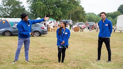 Antique experts Danny Sebastian, Roo Irvine and Tim Weeks stand in field at a car boot sale and antiques fair to participate in the Bargain Hunt 20th Anniversary Special.