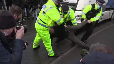 Man being carried away by police