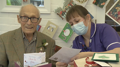 John with carer reading card