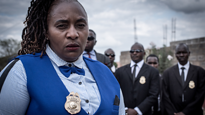 Detective Jane Mugo with her team in the background