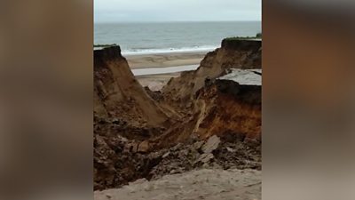 The coastguard warns mud has washed on to the beach and the cliff remains "very unstable".