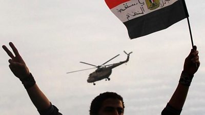 Man waves Egyptian flag as helicopter flies overhead (file photo)