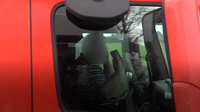 Man using two phones driving