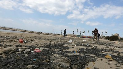 Tar is seen on the beach in the aftermath of an oil spill