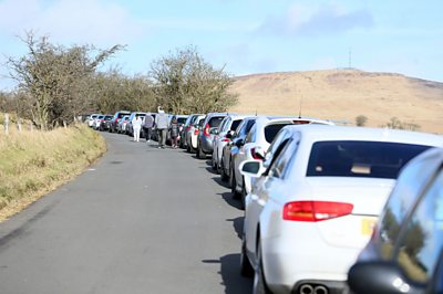 A line of cars parked a Divis Mountain in Belfast