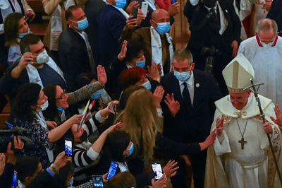 Pope greeted by crowds of people