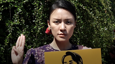 A Burmese protester displaying three-fingered salute