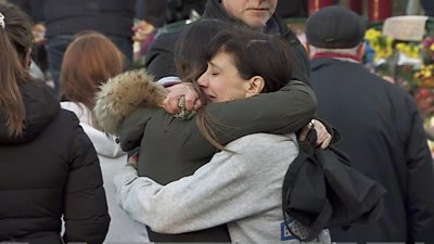 Two women hug