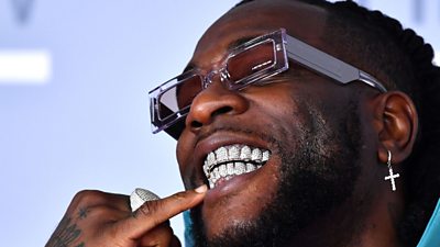 Burna Boy spilling with diamond encrusted teeth