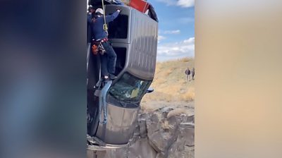 Paramedics describe rescue from truck hanging by a chain over canyon.