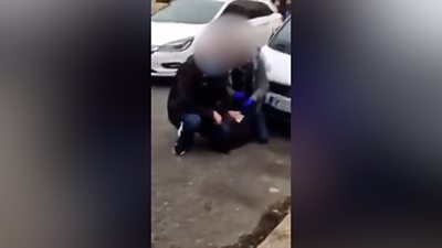 Man being held on the ground