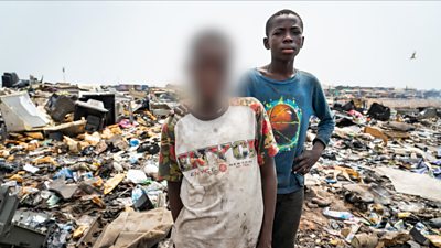 Malik, on the right, as a 'burner boy' on the Agbogbloshie dump in Accra, Ghana