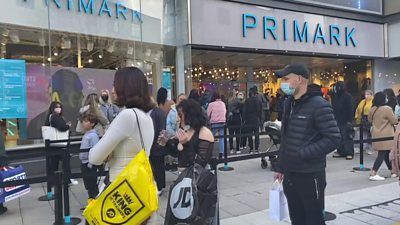 People queue outside a Primark shop.
