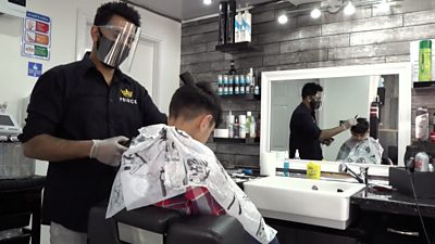 Barber cuts boy's hair