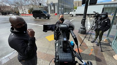 Photo of tv World production team filming on the streets during the coronavirus pandemic, all are wearing facemasks.