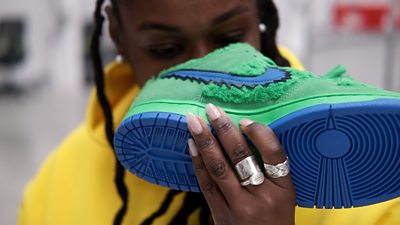Woman smelling trainers