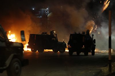 Police forces in cars fire tear gas