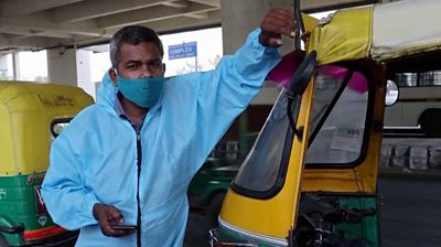 Raj Kumar next to his "tuk-tuk ambulance"